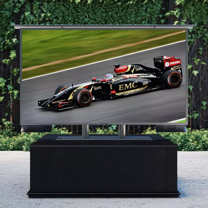 A black wooden box table with an outdoor TV on top in a relaxing backyard.