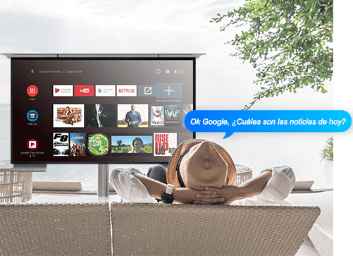 Man is lying on a sun lounger while controlling his outdoor TV using a Google Assistant.