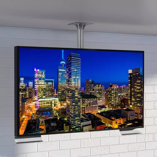 Ceiling-mounted outdoor TV in a white roofing and brick wall.