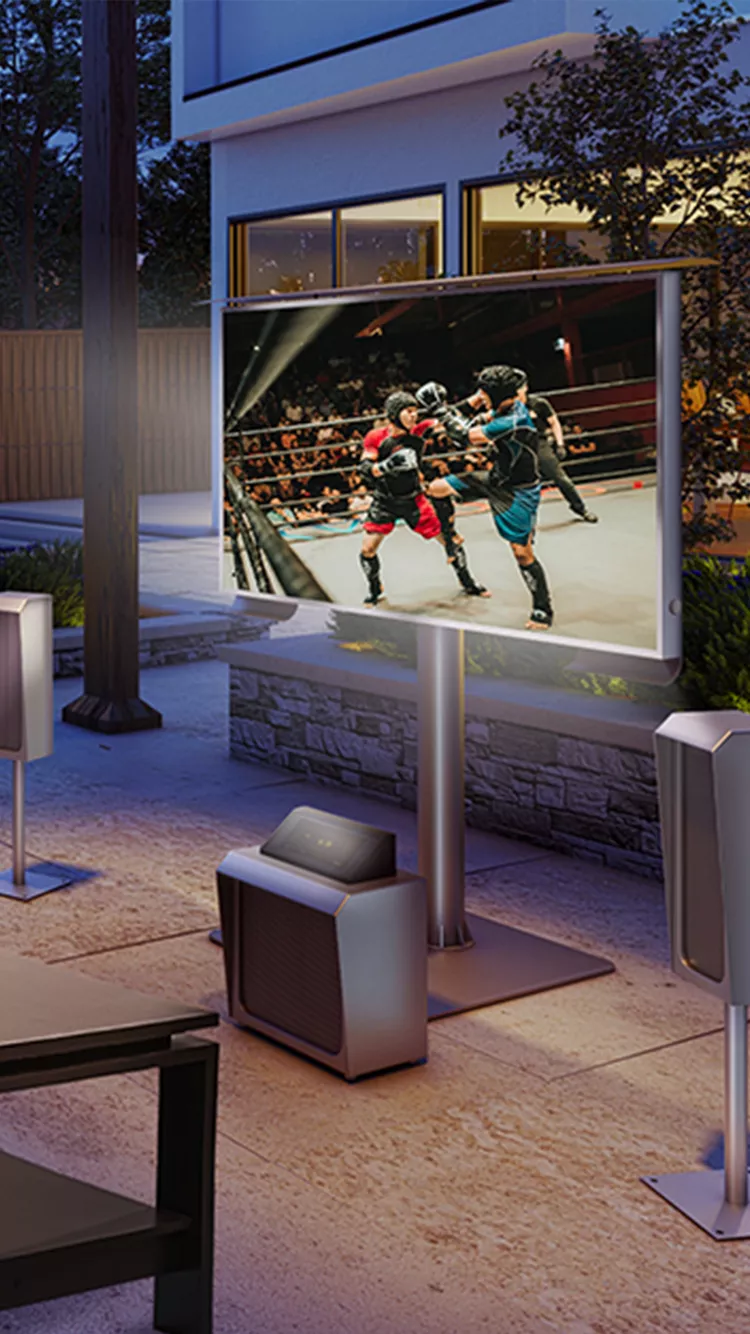 Self-standing outdoor TV on a cozy backyard net with external speakers.