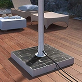 Stone base mount slate for outdoor TV with a rustproof post in a deck and furniture at the back.