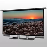 Outdoor TV in stainless steel desk mount with a seashore in a sunset shown on the screen.