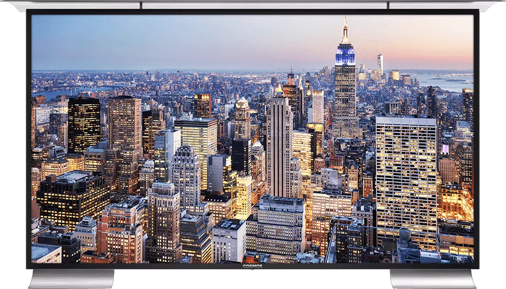 Outdoor TV with a sun cap and audio streamer displays tall buildings in a city.