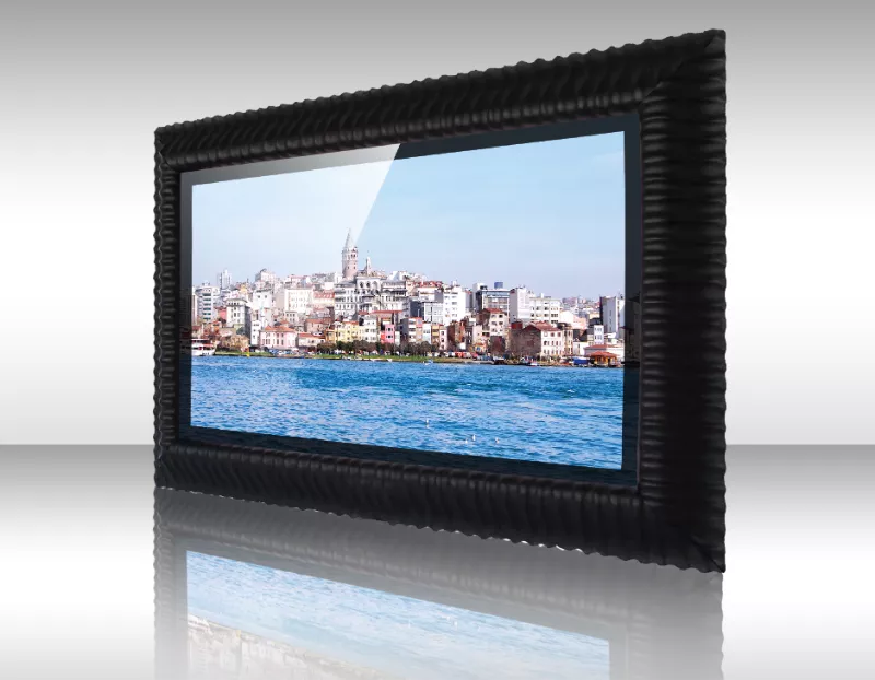 Un pueblo costero mostrado en un televisor espejo con marco Tanji negro.