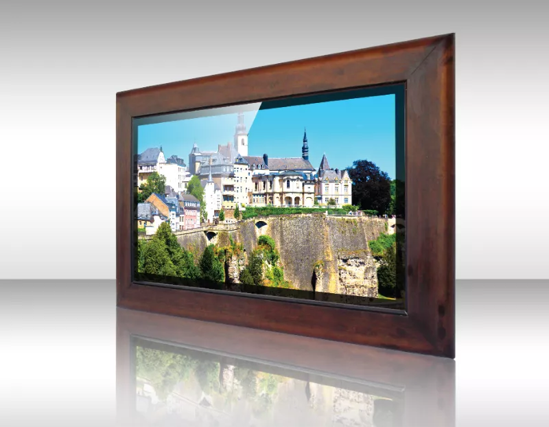 Presenta un histórico pueblo en colina con edificios de piedra en televisor espejo enmarcado.