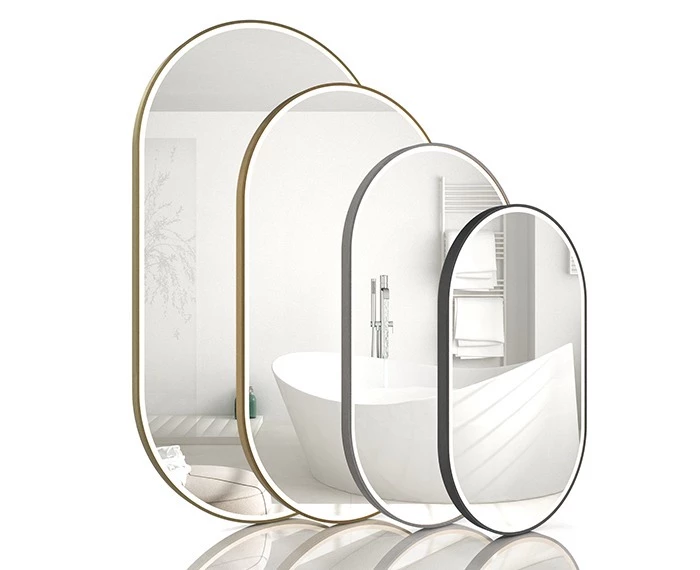 Oval lit mirrors in four different sizes and colors mirroring on a white surface in Abu Dhabi.