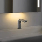 Bathroom faucet with a night light that shines from beneath the mirror.