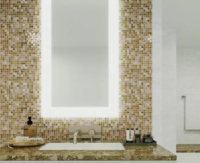Bathroom with a bathroom frosted mirror set on a green mosaic tiled wall above a sink in Abu Dhabi.