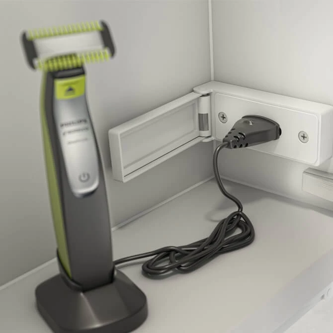 Plugged in electric razor in a power outlet from Abu Dhabi.
