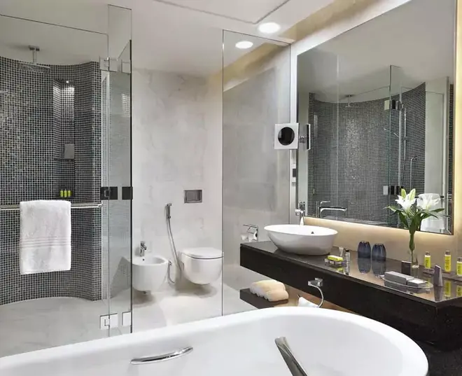 Broad backlit wall mounted mirror that creates ideal lighting for a sharp reflection from Ajman.