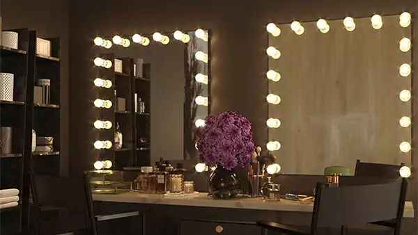 Tiny of a vanity cabinet containing two canvas foldable chairs are two Hollywood mirrors from Ajman.