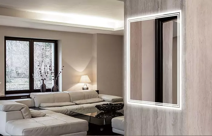 Modern living room in Ajman with sofa set, glass table, and a luxury led mirror on a textured wall.