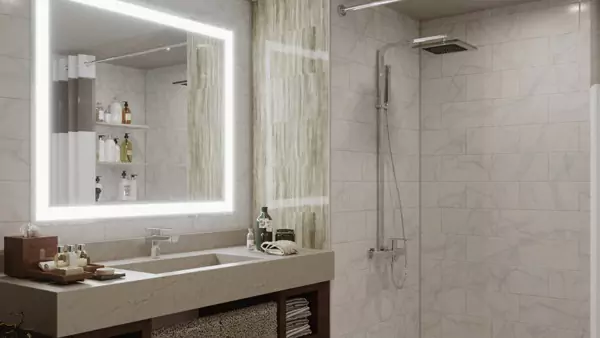 Mini of Grand Mirrors Lux on a tiled wall above a granite sink with bathroom essentials in Ajman.