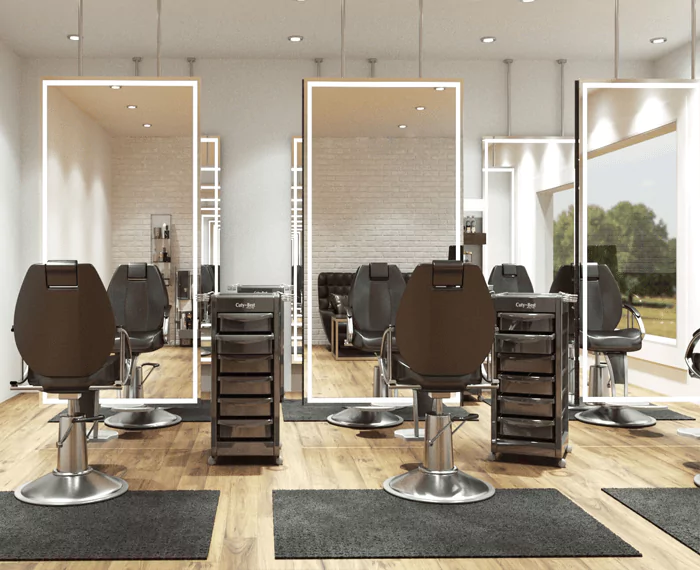Modern hair salon with rectangular vanity mirrors, hydraulic chairs, and trolley carts in Ajman.