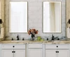 Compact of two oval lighted mirrors, and two sink vanity beside bathroom essentials in Kuwait.