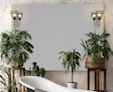 A compact, chic bathroom including a tub, lovely plants, and a Casazza perfect mirror from Dubai.
