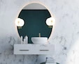 Dubai wall of white marble is a thumb-sized circular versatile mirror with a chianti bulb.