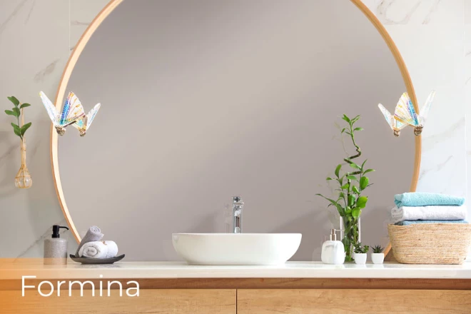 In a bathroom, a round versatile mirror with chic formina lamp provides enough of light from Dubai.