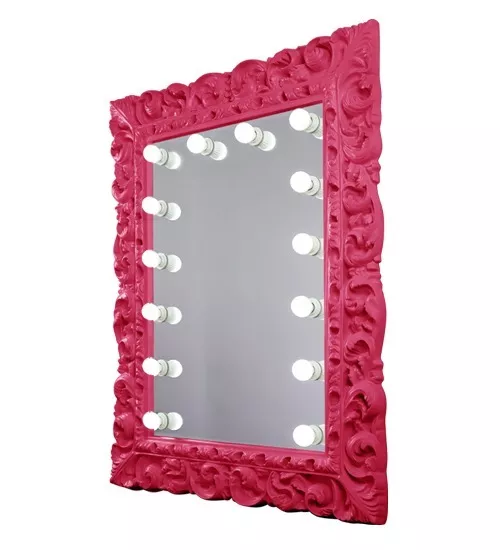 Pink patterned framed mirror with illuminated bulbs around its perimeter in Ajman.