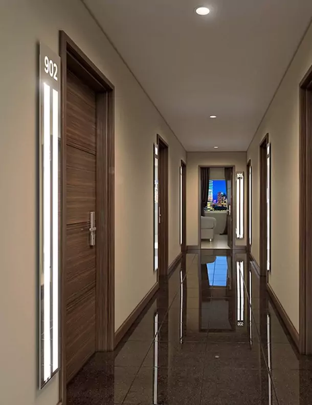 Luxurious hotel corridor with bespoke lighted mirrors and a glossy brown ceramic tiles in Dubai.