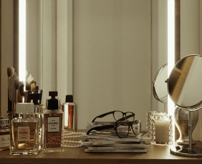 Extra thin lighted mirror with branded perfumes and an eyeglass on a pile of magazines in Oman.