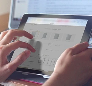 Hands using a digital tablet with a screen displaying a website design template in Bahrain.