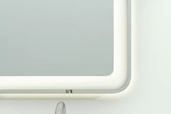 Grand Mirrors Lux mounted on a white concrete wall with a high quality lighting in Sharjah.