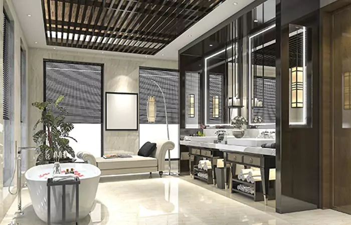Modern bathroom with a free-standing white bathtub and a hotel bathroom mirror lighting in Ajman.