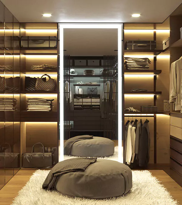 Preview of walk in closet in Kuwait with folded clothes in shelves and a custom lighted mirror.