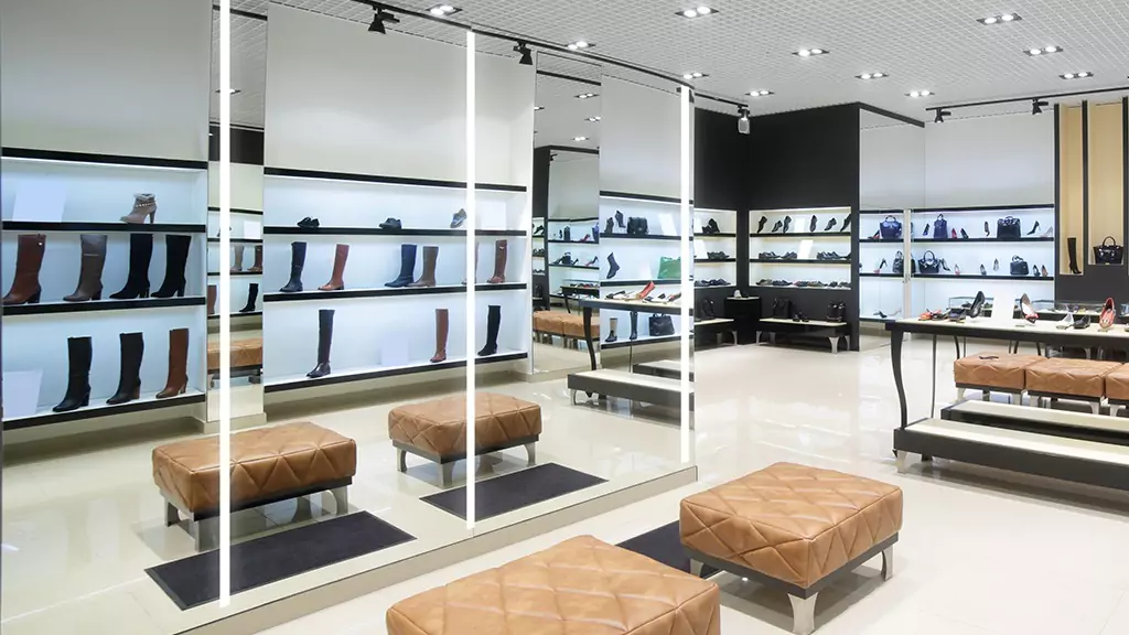 Elegant shoe and bag store in Kuwait with evervue lighted mirrors and leather coated chairs.