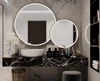 Thumbnail of two different sized oval lighted mirrors and a single sink in Dubai.