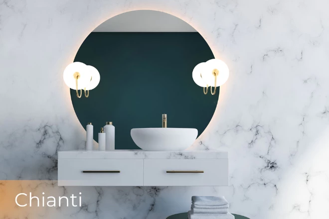 Ajman cabinet sink of white marble is a circular lighted vanity mirror with Chianti lamp behind it.