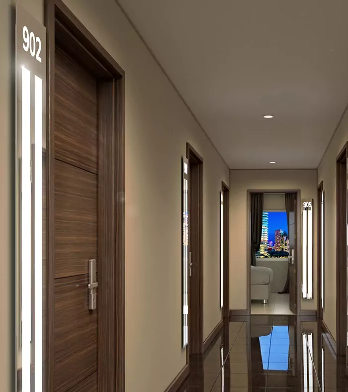 Hotel hallway with light strips near each hardwood door in UAE.
