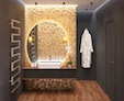 A basin is lies atop a golden mosaic wall with a bancole lamp inside a versatile mirror from Al Ain.
