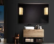 Al Ain medicine cabinet on a black wall is a modern led magnifying mirror with a Mascioni lamp.