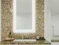 Tiny of bathroom with a lighted mirror mounted on a green mosaic tiled wall and a sink below in Oman.