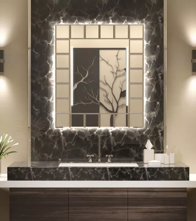 Sleek backlit lighted mirror from Oman above a spotless sink in a black ceramic tiled wall.