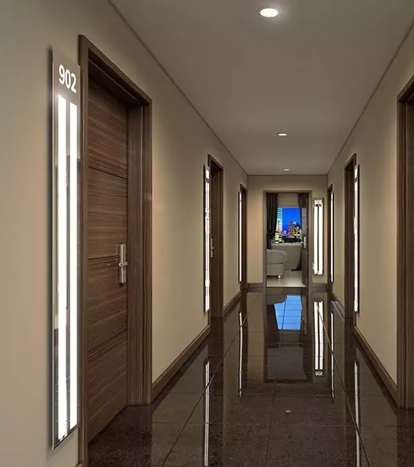 Hotel corridor with shiny brown tiled floor and lighted mirrors at the side of the doors in Kuwait.
