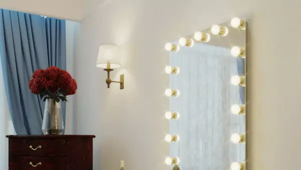 Hollywood mirror with a wall light and a flower vase atop the file cabinet on the side from Oman.