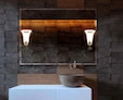Sharjah brown stone sink bowl is a small piloni lamp housed and a magical lighted mirror.