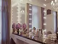 Icon of a Hollywood mirror, a countertop cabinet with a beauty kit and necessities from Qatar.