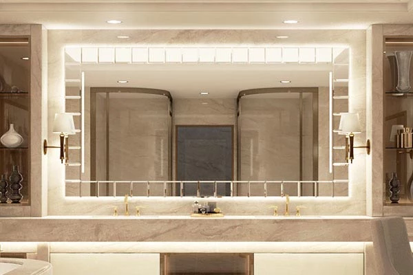 Grand Mirrors Deco recessed on a marble wall with two marble sinks and golden faucets in Ajman.