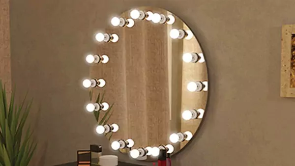 Hollywood circular mirror set into a brown wall from Saudi Arabia.