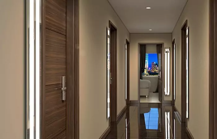 A narrow hotel corridor and wooden doors with luxury LED mirrors and a glossy floor in Al Ain.