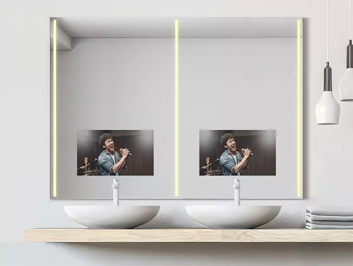 Double sink philips mid-warm lighted mirror TV set on a white wall with a folded towel on the side.