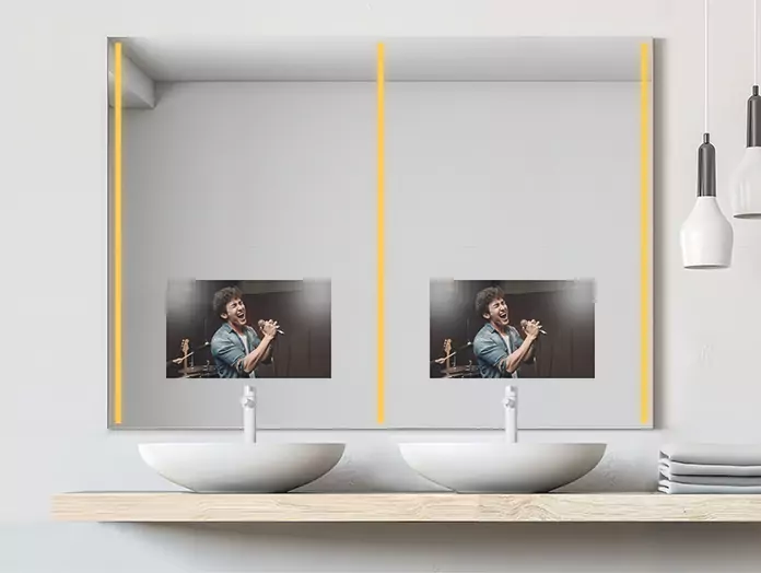 Double-sink philips warm-lighted mirror TV displays a man singing on the screen.