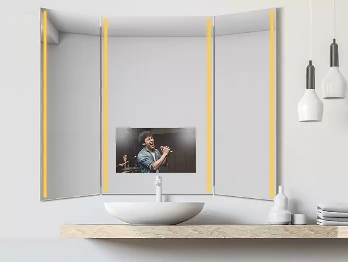 Trifold mirror TV with a warm light displays a man singing at a concert.