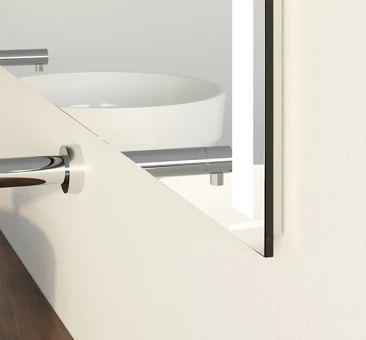 Sleek mirror in cool light mounted on the wall.