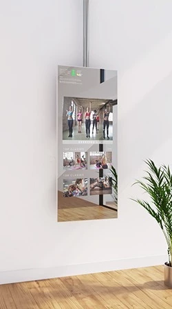 A white wall displays the fitness mirror in ceiling mount design, showing videos for exercising.