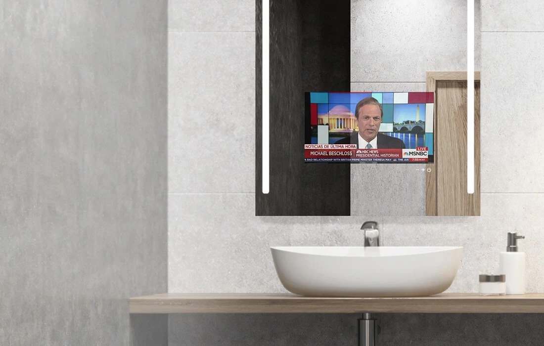 A bathroom with a wall-mounted lighted smart mirror.